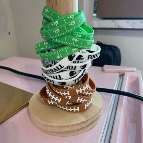 GREEN YARDS SILICONE FOOTBALL BRACELET SET OF 3 (YARD LINES, FOOTBALL LACES & HELMET)